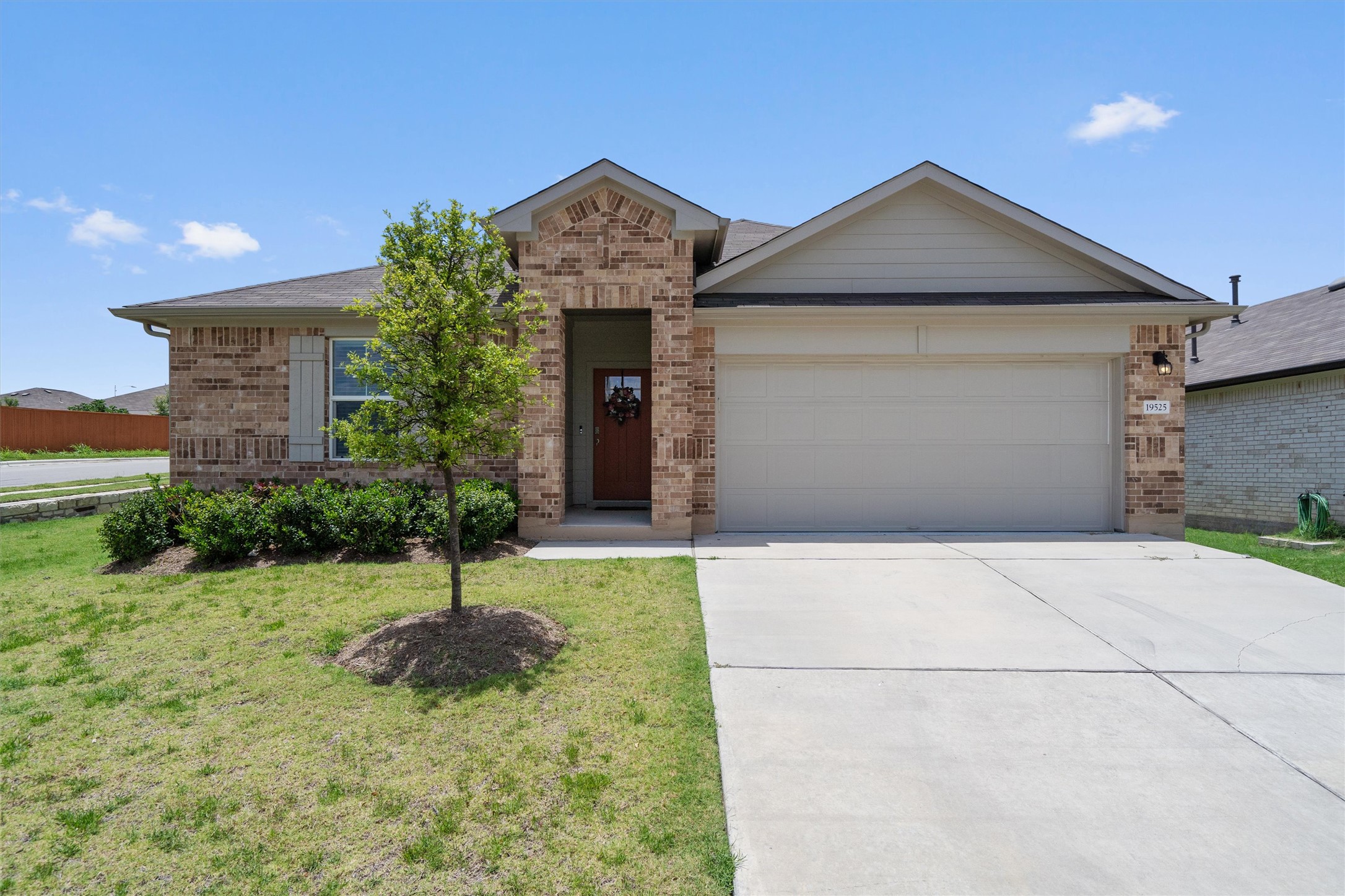 19525 Abigail Fillmore Road Manor, TX 78653 - Photo 35 of 38 A classic brick facade and tidy landscaping create welcoming curb appeal for this charming single-story residence.