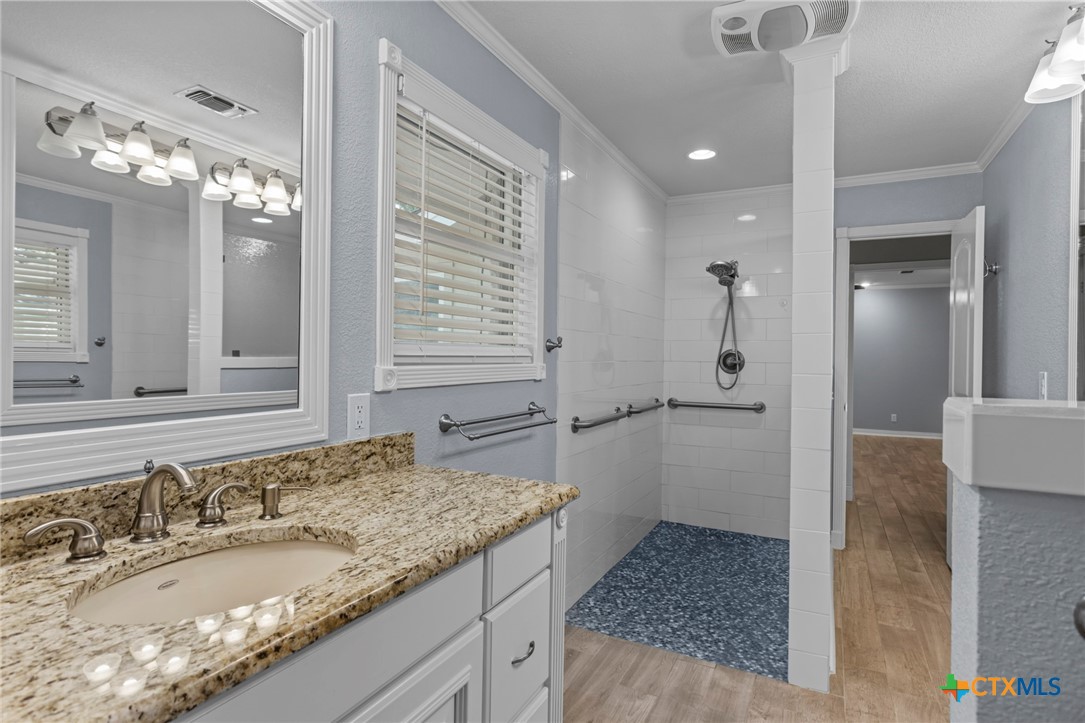3745-3735 Canyon Heights Road Belton, TX 76513 - Photo 31 of 45 a bathroom with a granite countertop sink and a mirror