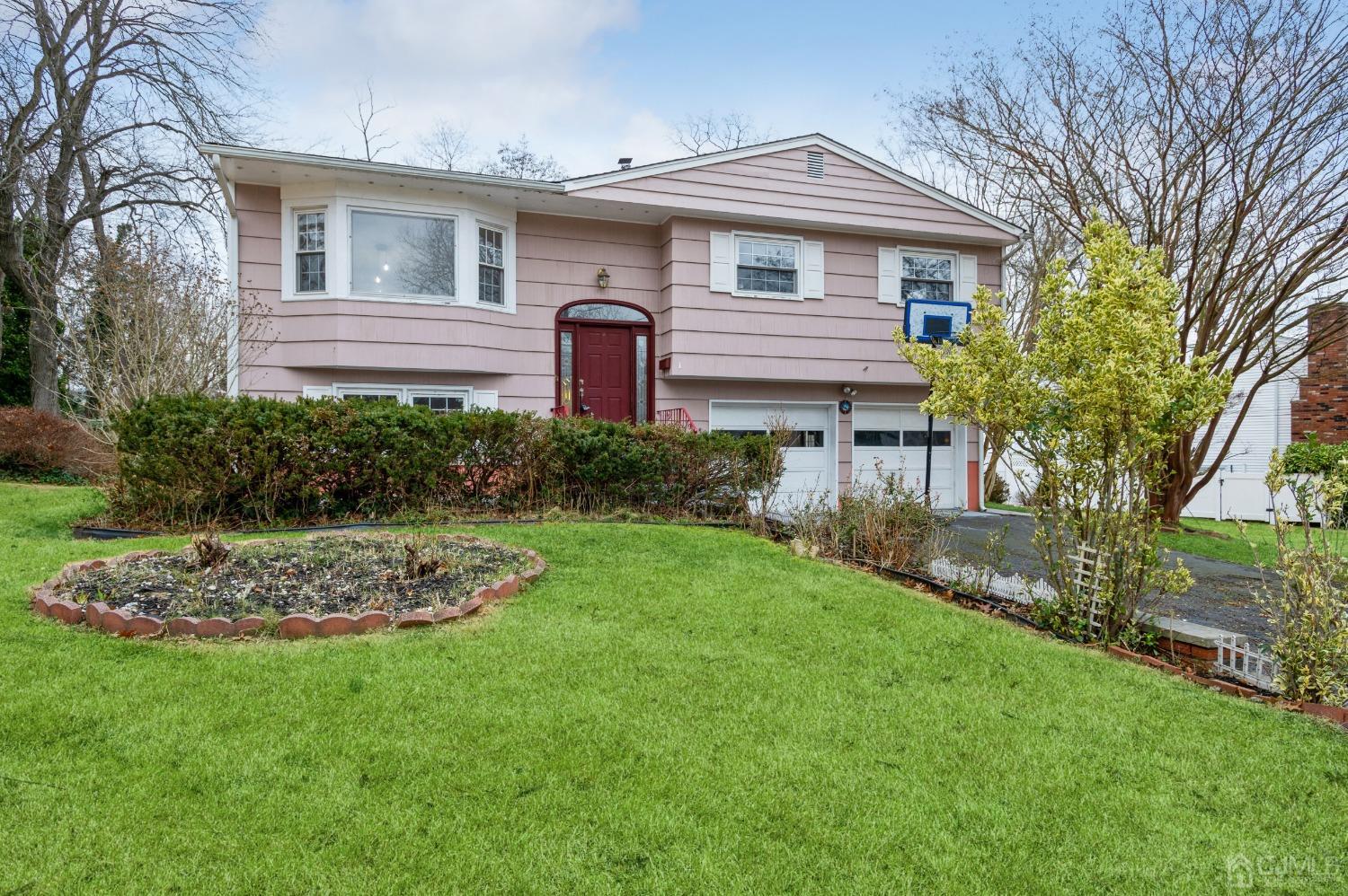 1 Bruce Road East Brunswick, NJ 08816 - Photo 1 of 21 a front view of a house with a garden