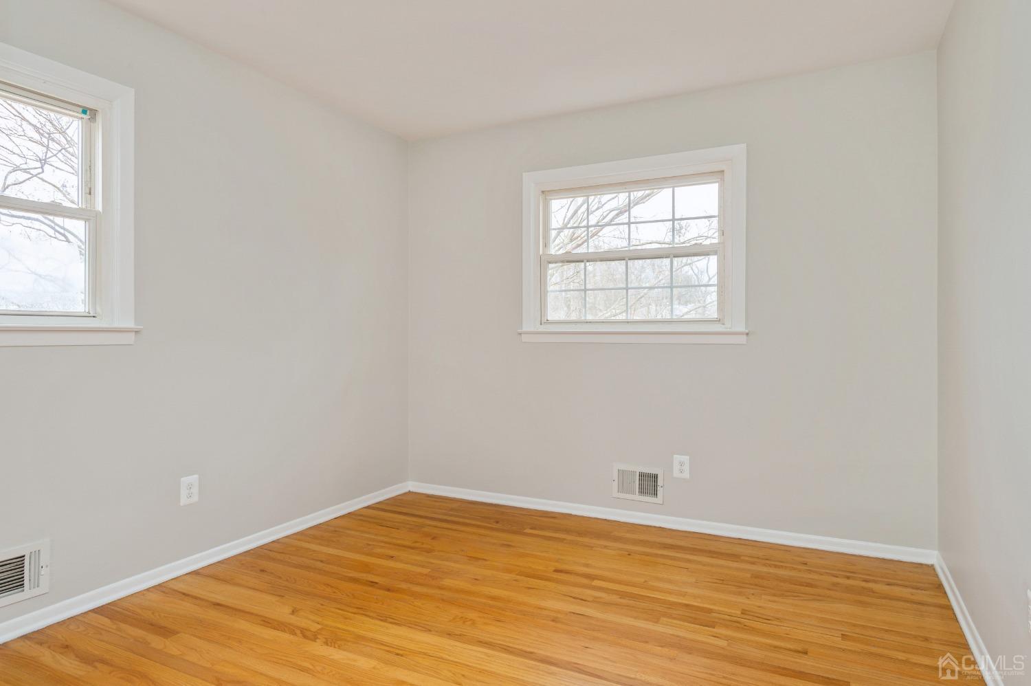 1 Bruce Road East Brunswick, NJ 08816 - Photo 12 of 21 an empty room with wooden floor and windows