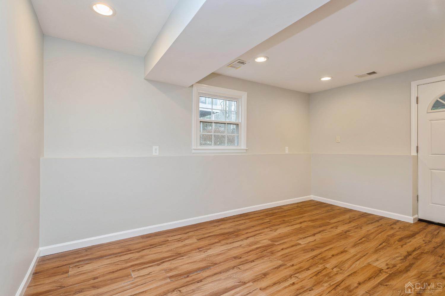 1 Bruce Road East Brunswick, NJ 08816 - Photo 17 of 21 a view of empty room with wooden floor and fan