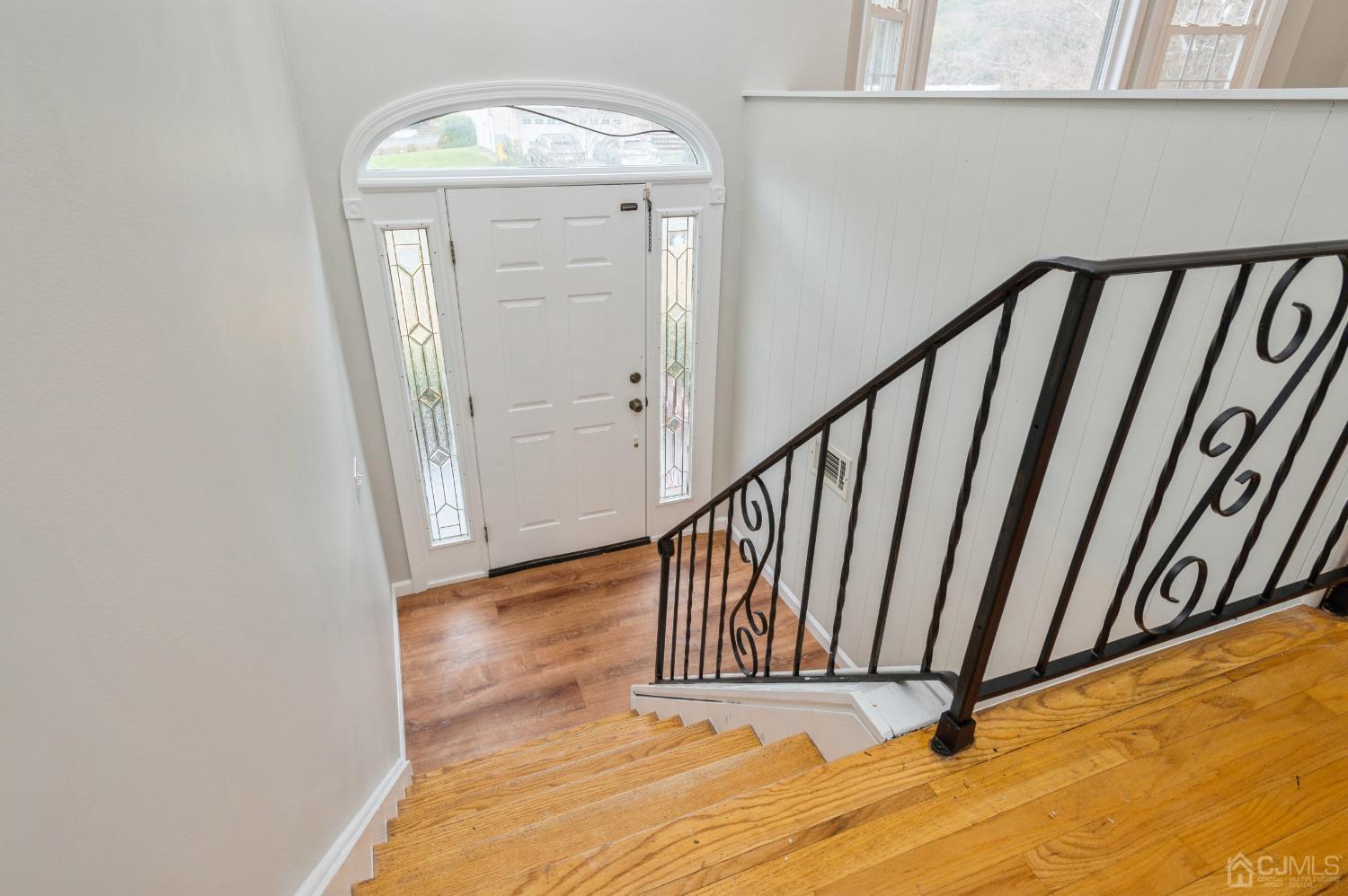 1 Bruce Road East Brunswick, NJ 08816 - Photo 2 of 21 a view of a hallway with wooden floor and staircase