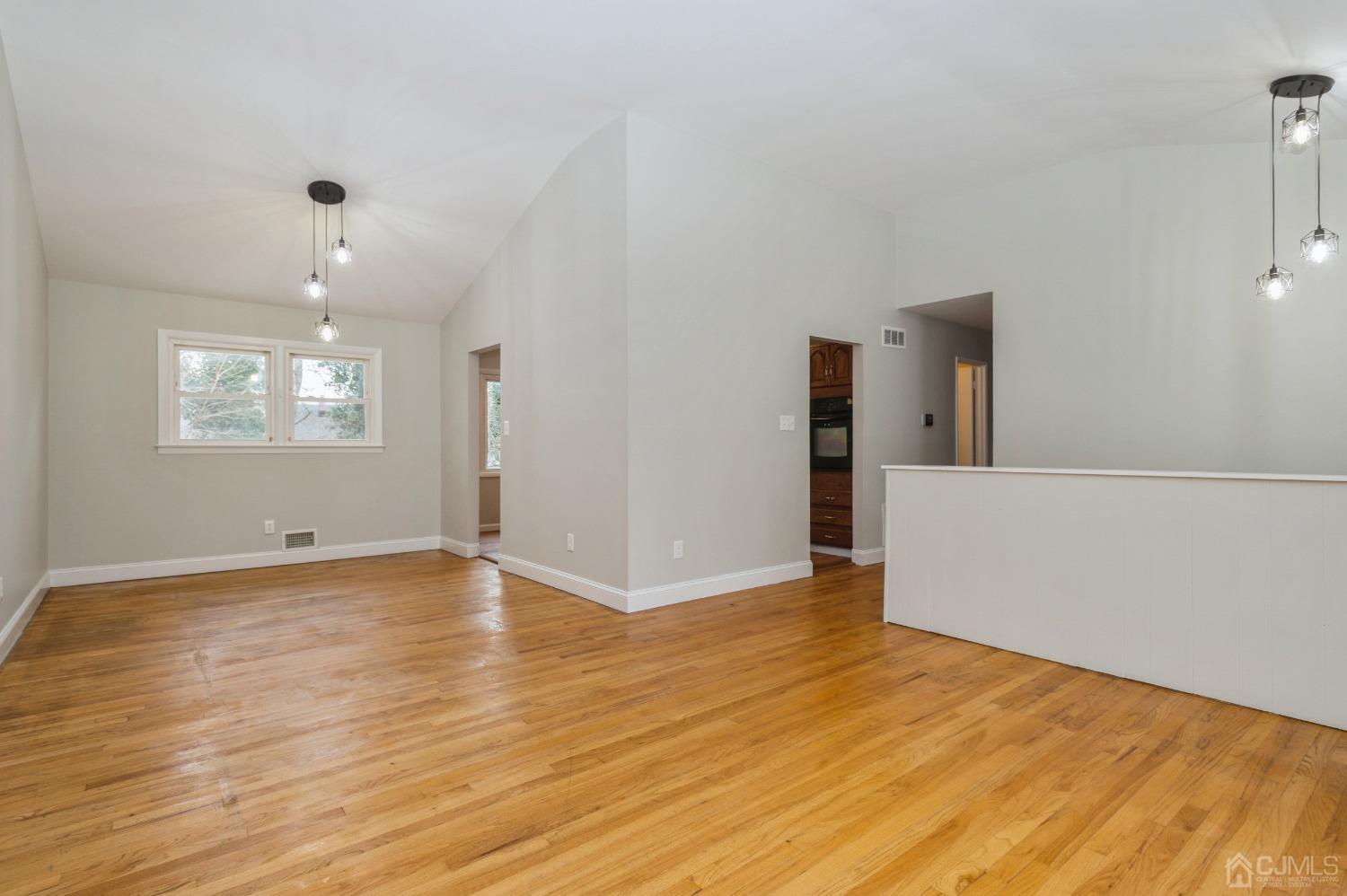 1 Bruce Road East Brunswick, NJ 08816 - Photo 3 of 21 a view of an empty room with wooden floor and a window