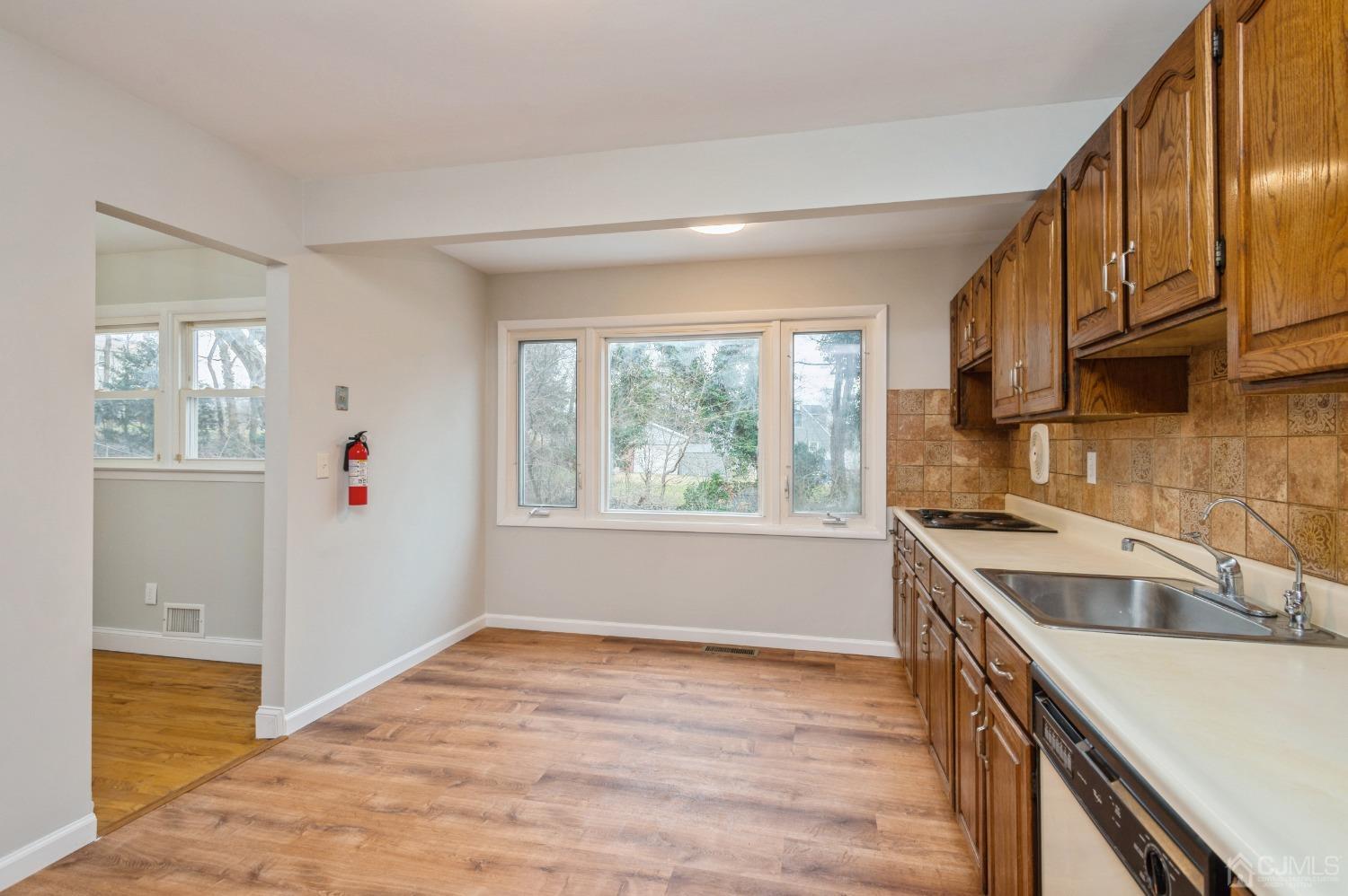 1 Bruce Road East Brunswick, NJ 08816 - Photo 7 of 21 a kitchen that has a sink a stove and a window