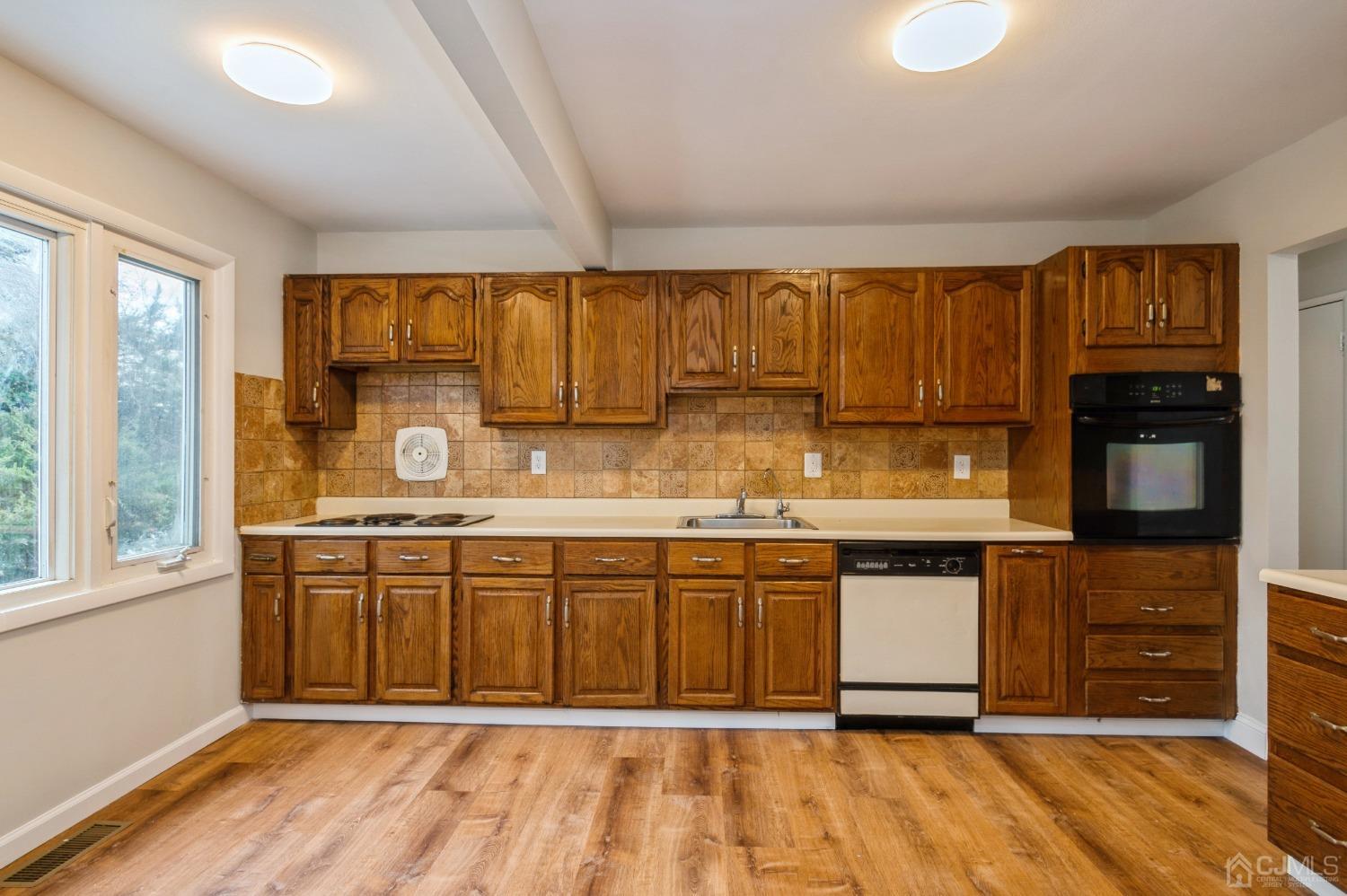 1 Bruce Road East Brunswick, NJ 08816 - Photo 8 of 21 a kitchen with stainless steel appliances granite countertop a sink and cabinets