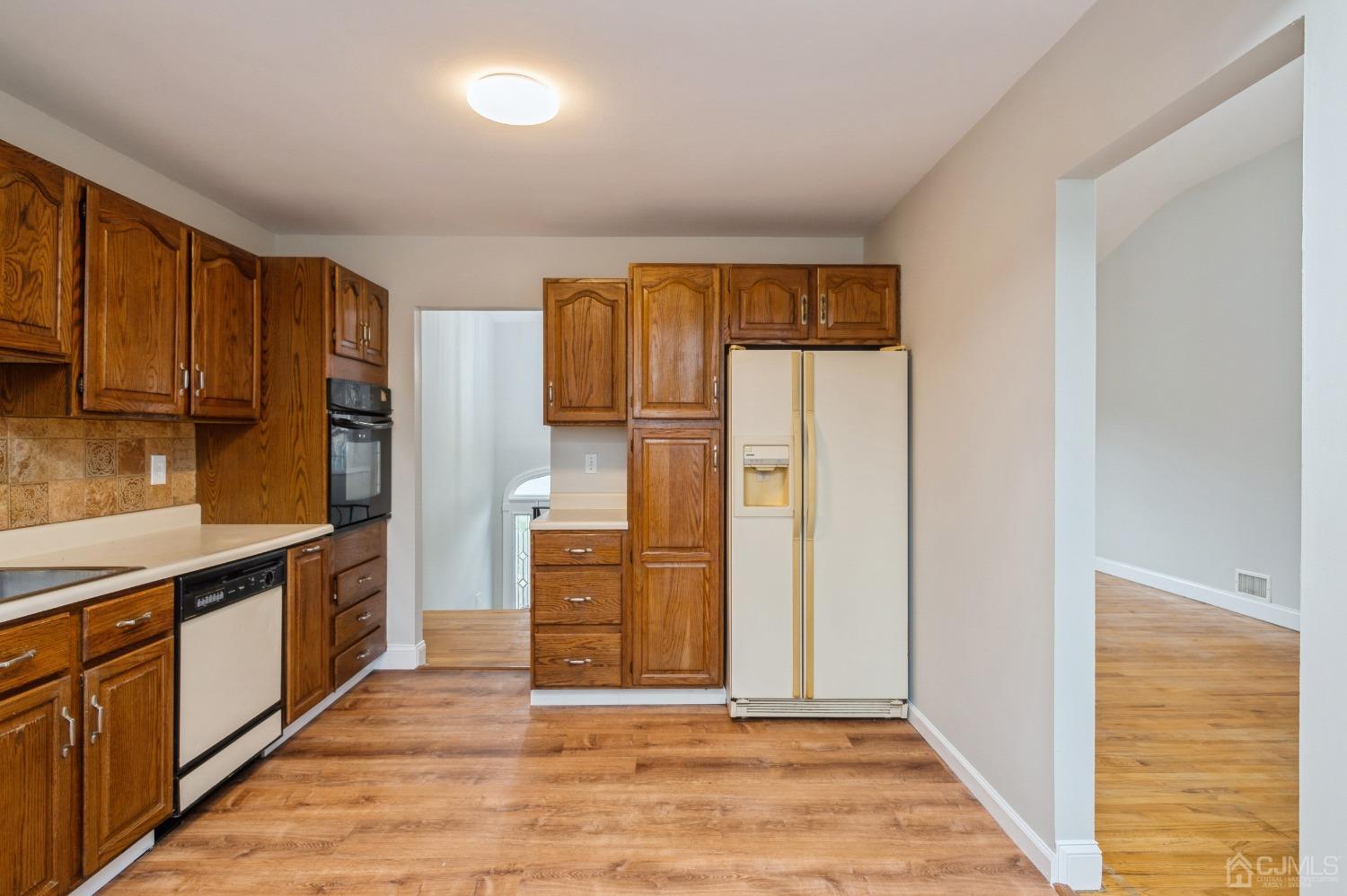 1 Bruce Road East Brunswick, NJ 08816 - Photo 9 of 21 a kitchen with stainless steel appliances granite countertop a refrigerator and a stove top oven