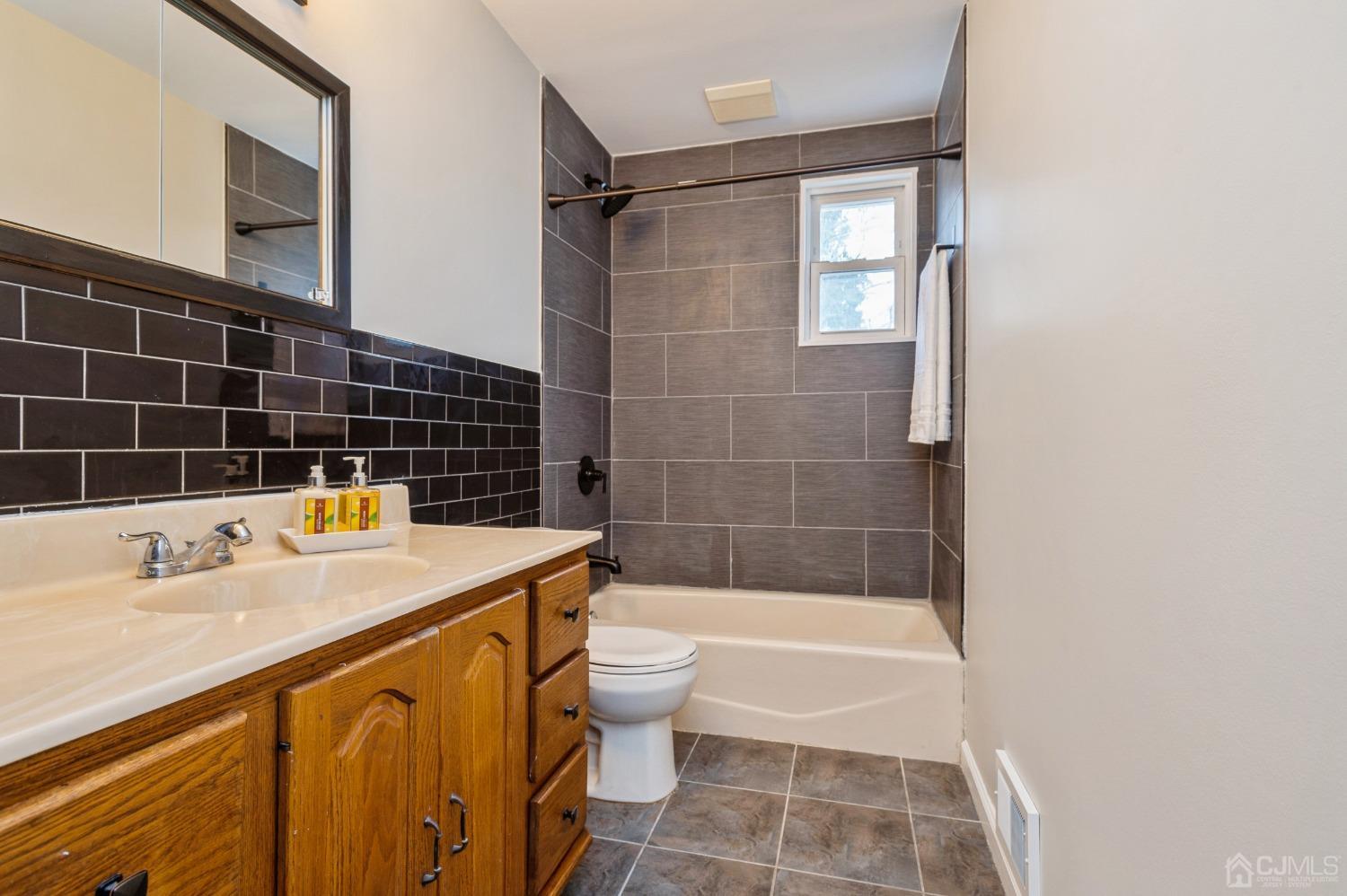 1 Bruce Road East Brunswick, NJ 08816 - Photo 10 of 21 a bathroom with a sink a blue toilet and shower