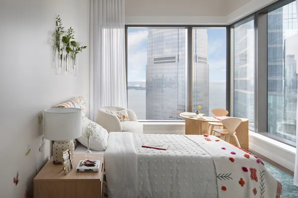 a bed room with a bed and a chair