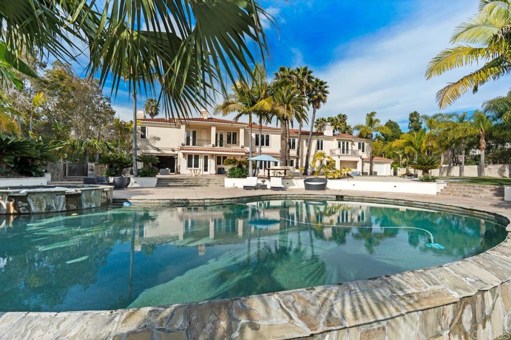 6773 Poco Lago Rancho Santa Fe, CA 92067 - Photo 57 of 65 a view of swimming pool that has lawn chairs plants and palm trees