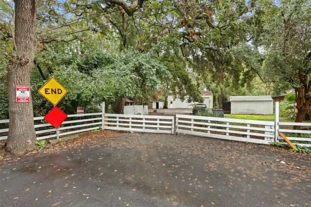 a view of a room with stairs and wooden fence
