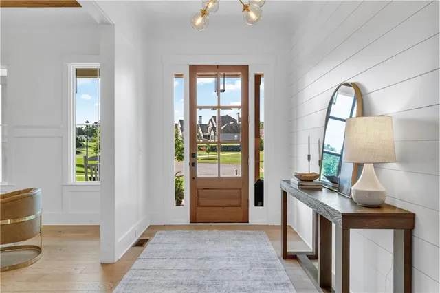 a large kitchen with cabinets table and chairs