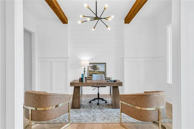 a view of a dining room with furniture large windows and wooden floor