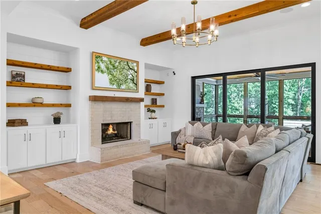 a living room with furniture and a floor to ceiling window