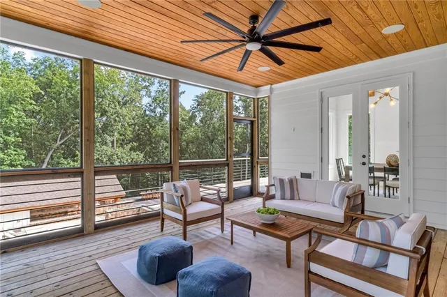 an aerial view of a house with swimming pool and large trees