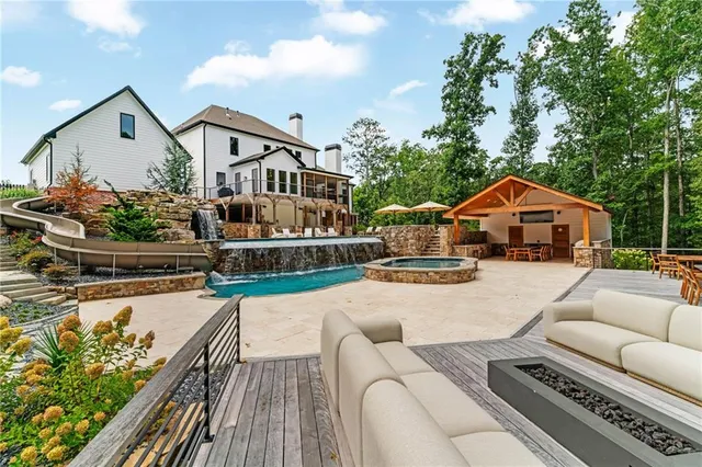 a view of a house next to a yard with big trees