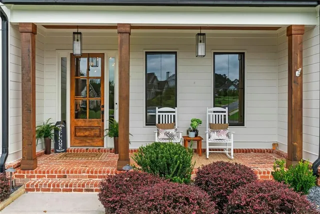 a living room with furniture a fireplace and a chandelier