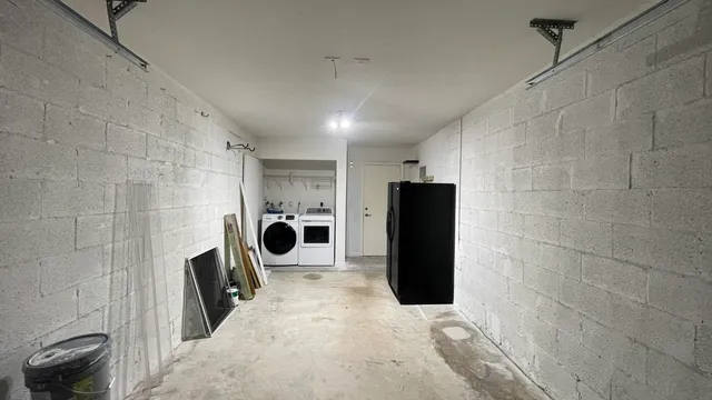 an empty room with wooden floor chandelier fan and windows