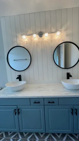 a bathroom with a toilet a sink and a mirror