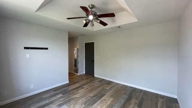 wooden floor in an empty room with a window