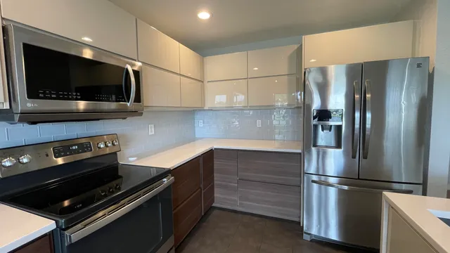 a kitchen with stainless steel appliances a refrigerator and a sink