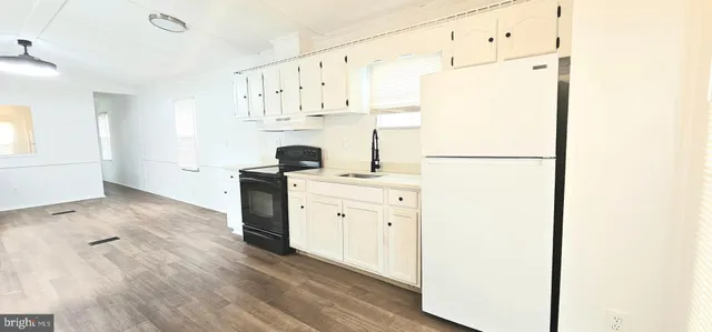 a kitchen with cabinets a refrigerator and a stove