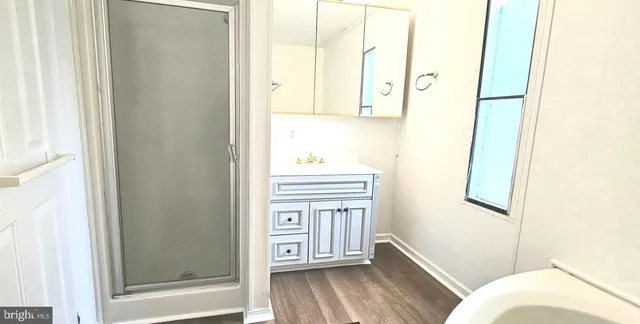 a bathroom with a window and a bath tub