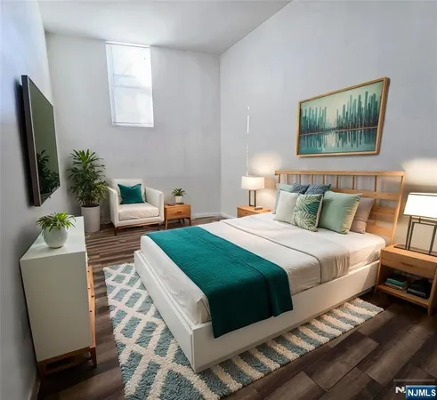 a bedroom with furniture and a flat screen tv