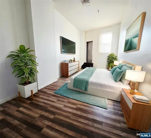 a living room with furniture potted plant and a flat screen tv