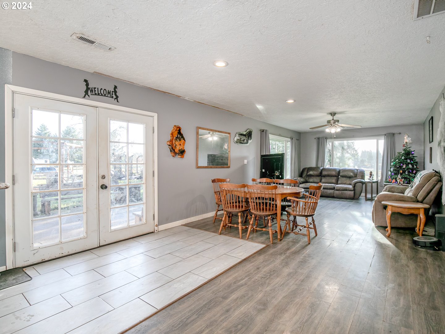 24502 South Springwater Road Estacada, OR 97023 - Photo 17 of 48 a living room with furniture a large window and wooden floor
