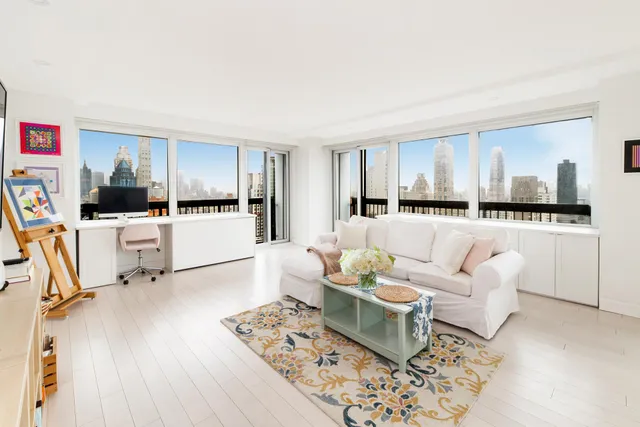 a living room with furniture and kitchen view