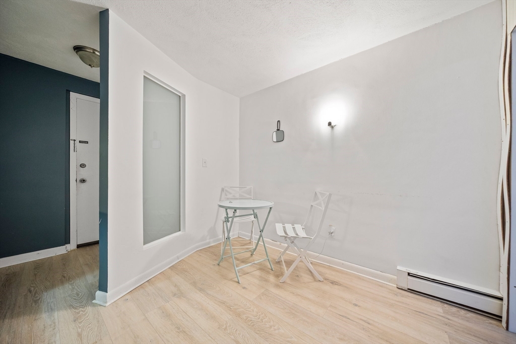 915 Edgell Road, Unit 77 Framingham, MA 01701 - Photo 4 of 15 a view of wooden floor and chair in a room