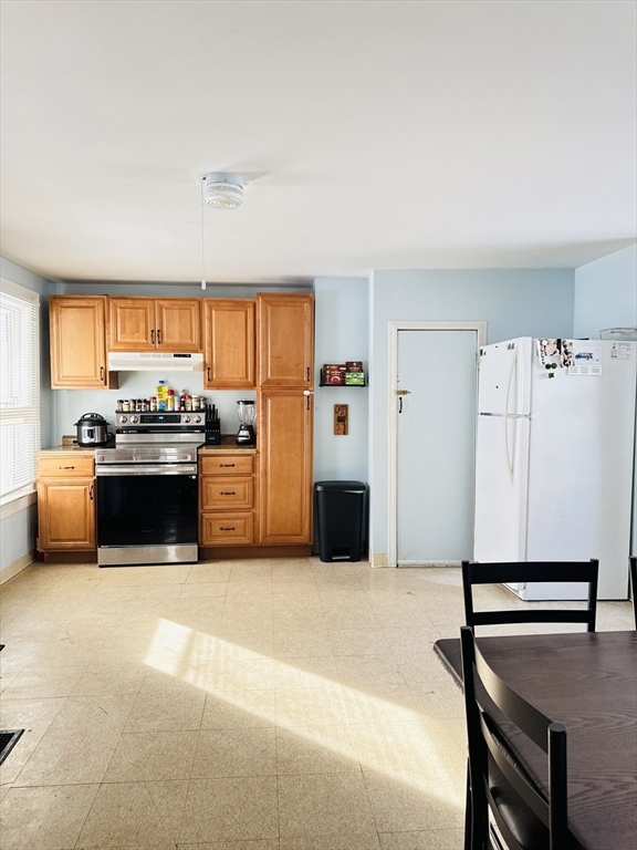 8 Water Street Greenfield, MA 01301 - Photo 3 of 21 a kitchen with stainless steel appliances a stove a refrigerator and a more cabinets