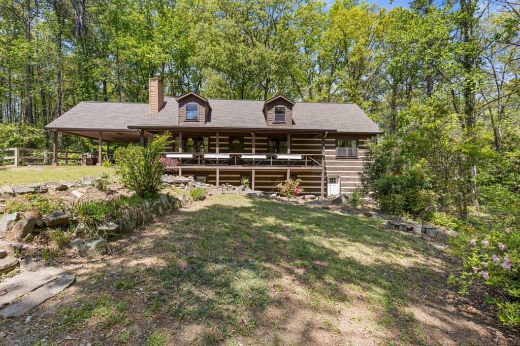 a backyard of a house with table and chairs