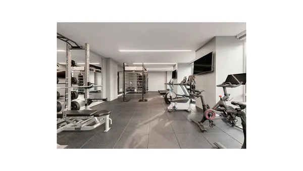 a living room with furniture and gym equipment