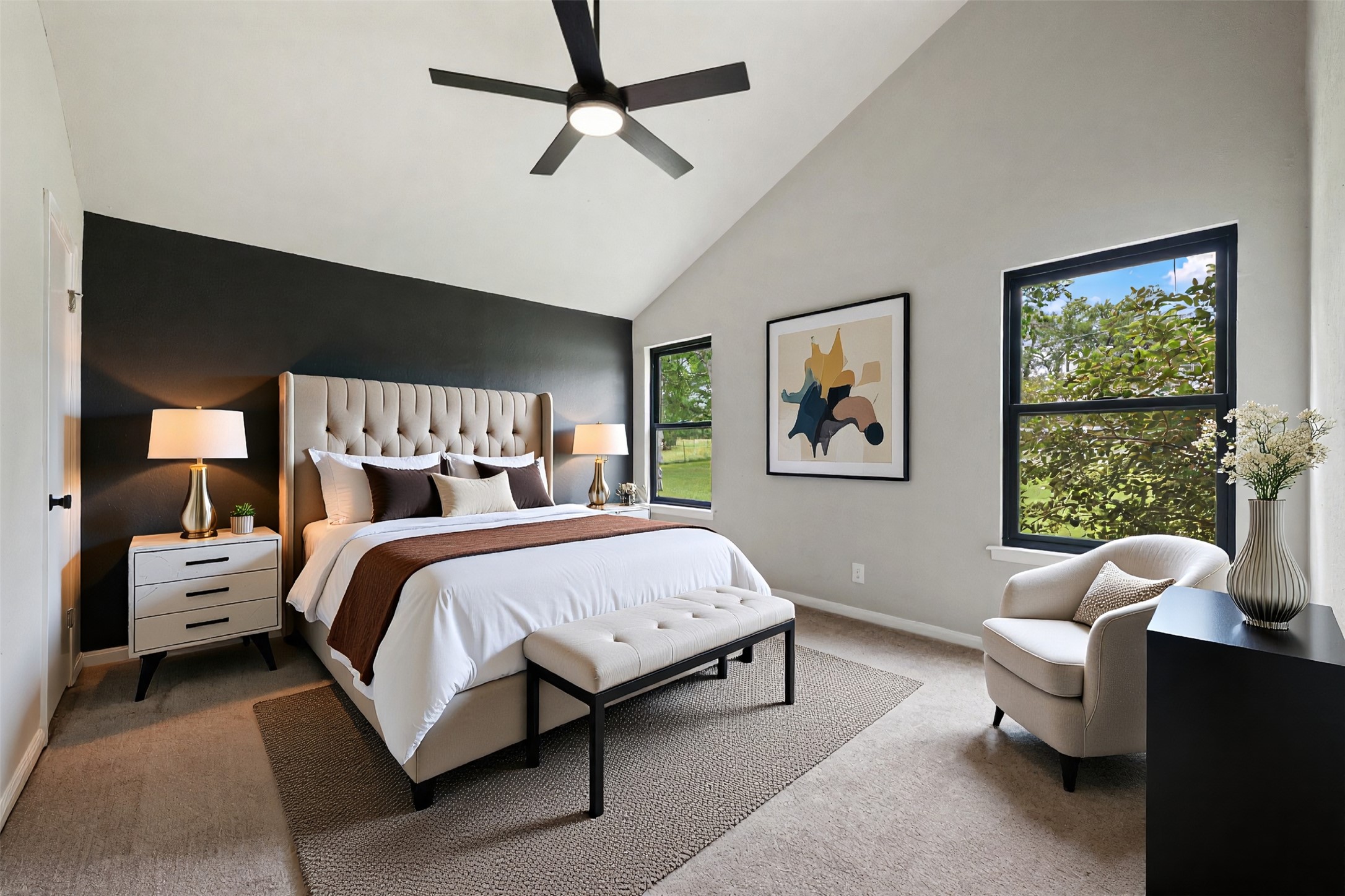 1600 Pin Oak Lane Round Rock, TX 78681 - Photo 32 of 40 Spacious room featuring vaulted ceilings, a prominent accent wall, two large windows, a ceiling fan, and carpeted flooring