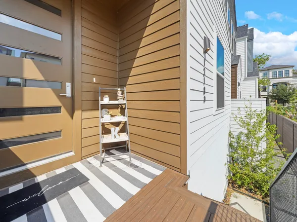 a view of a balcony with chairs and a stove