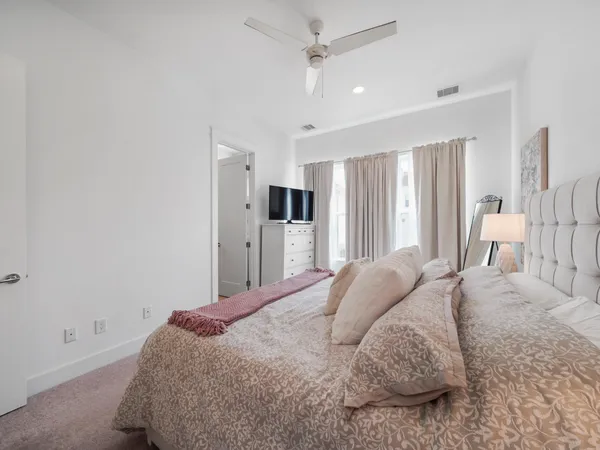 a spacious bedroom with a bed and a cabinets