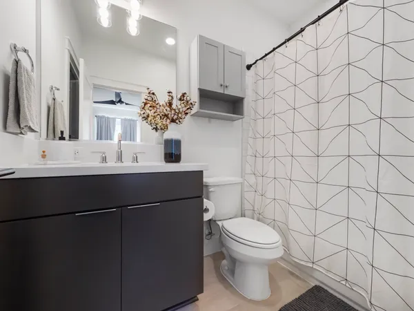 a bathroom with a sink toilet and shower
