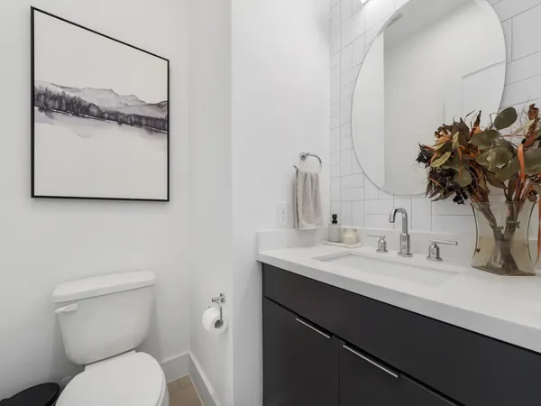 a bathroom with a toilet sink and mirror