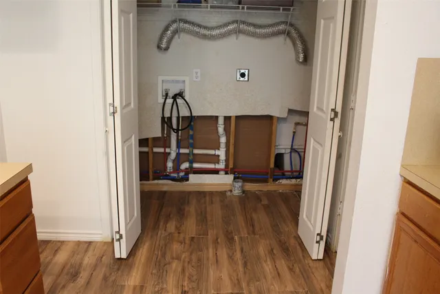 a kitchen with a cabinets and white appliances
