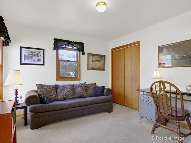318 East Elm Street Wheaton, IL 60189 - Photo 13 of 17 a living room with furniture a couch and a window