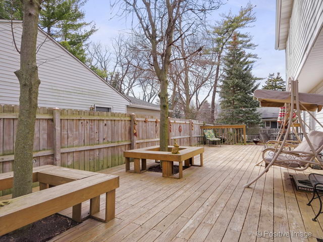 318 East Elm Street Wheaton, IL 60189 - Photo 14 of 17 a view of a roof deck with table and chairs with wooden floor and fence