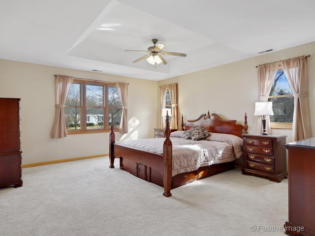 318 East Elm Street Wheaton, IL 60189 - Photo 10 of 17 a bedroom with a bed lamp and window
