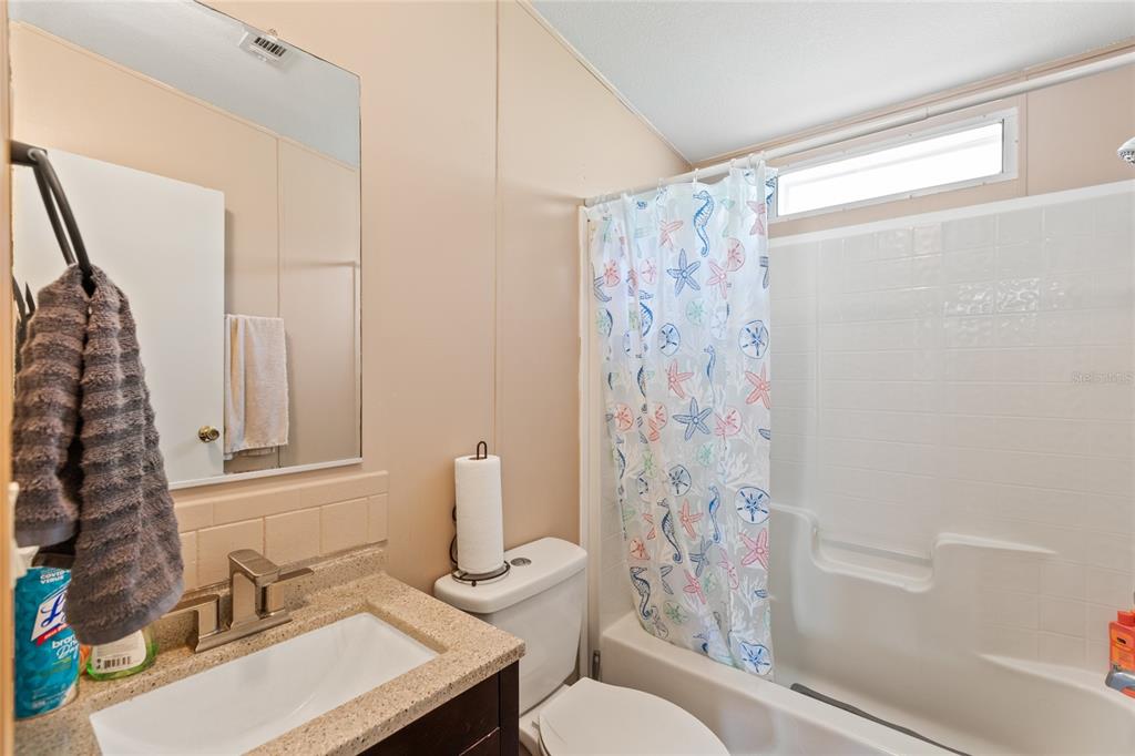 5670 Acadia Street Keystone Heights, FL 32656 - Photo 55 of 65 a bathroom with a sink toilet and shower