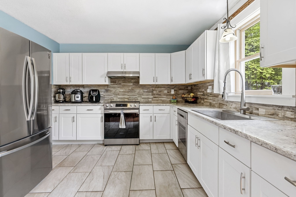 22 Lyon Hill Road Chester, MA 01011 - Photo 13 of 38 a kitchen with cabinets stainless steel appliances a sink and a counter space