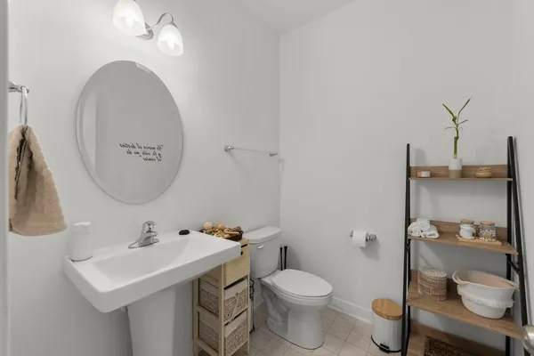 a bathroom with a toilet a sink and mirror