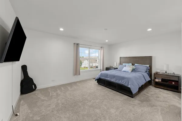 a bedroom with a bed and a flat screen tv