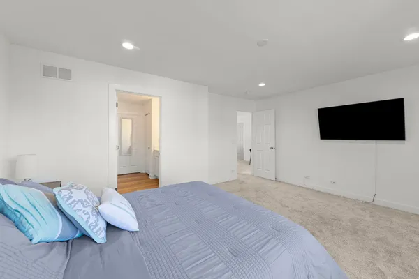 a bedroom with a bed tv and a couch