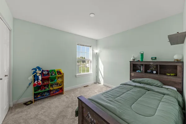 a bedroom with furniture and a window