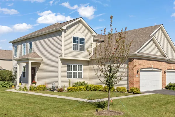 a front view of a house with a yard